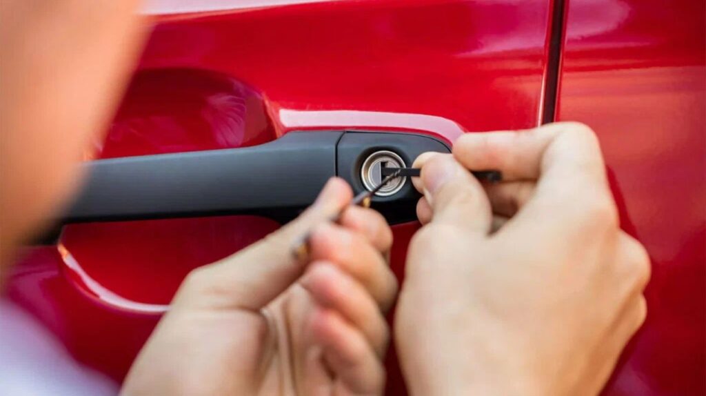 Professional locksmith unlocking a car door using specialized tools.