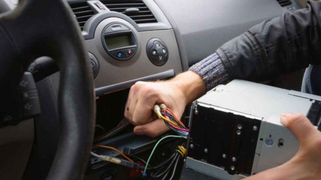 Professional installer wiring and programming remote start system for a manual car.