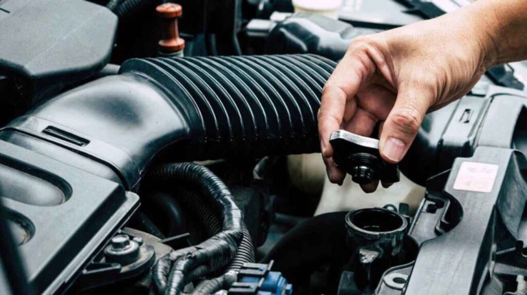 Mechanic converting a Volvo marine engine for car use with radiator setup.